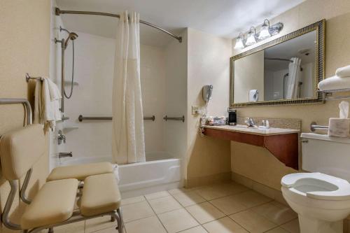 a bathroom with a toilet and a sink and a shower at Suburban Studios Arlington Heights Elk Grove in Arlington Heights