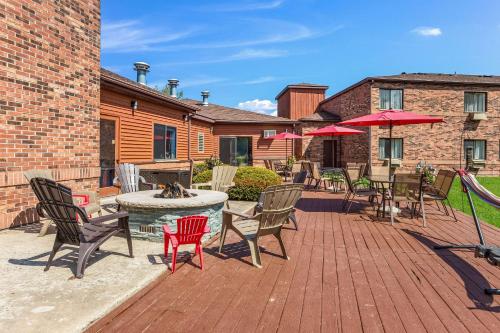 a patio with chairs and a table and umbrella at Quality Inn Petoskey-Harbor Springs in Petoskey