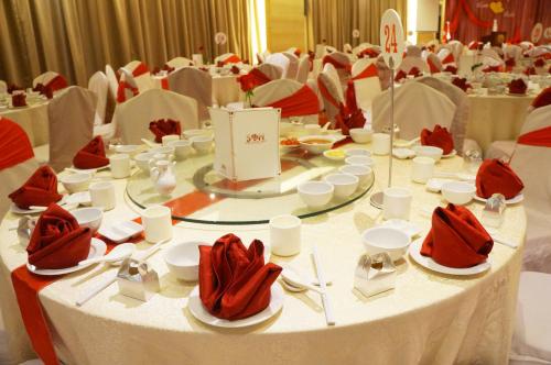 a long white table with red napkins on it at Sabah Oriental Hotel in Kota Kinabalu
