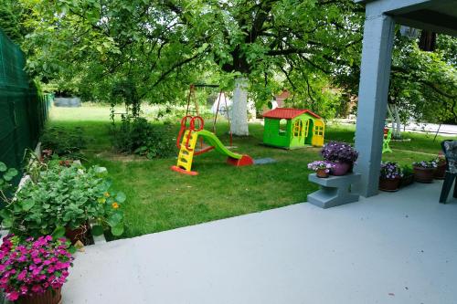 a backyard with a playground and a play house at Ammy apartment in Sarajevo