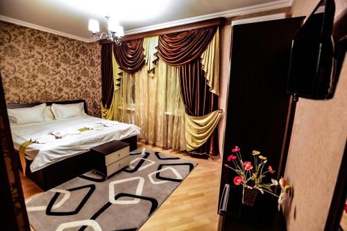 a hotel room with a bed and a rug with at Hotel S.R in Tbilisi City