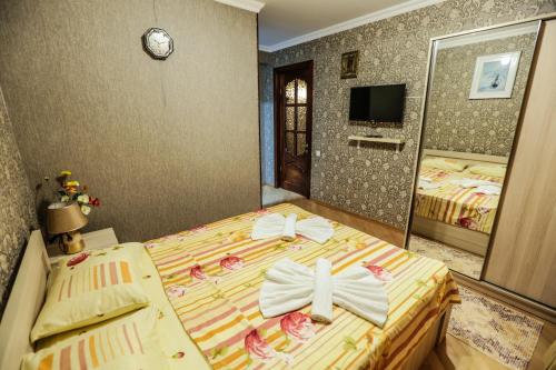 a bedroom with a bed with a cross on it at Hotel S.R in Tbilisi City