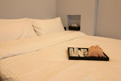 a tray of shoes sitting on top of a bed at Lukang Barn Inn in Lugang