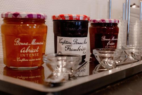 a shelf with three jars of honey on it at Cerise Nantes Atlantis in Saint-Herblain