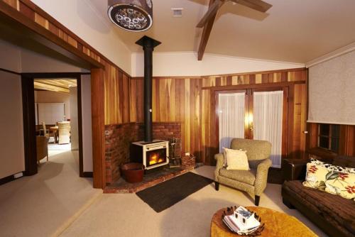a living room with a fireplace and a couch at Cable Station Accommodation in Stanley