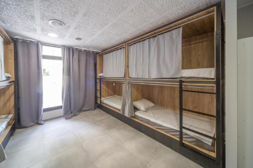 a room with three bunk beds in it at Faro SOLO para MUJERES in Platja d'Aro