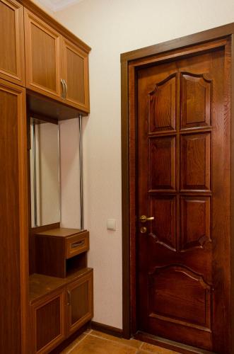 an empty room with a wooden door and a mirror at Hotel S.R in Tbilisi City