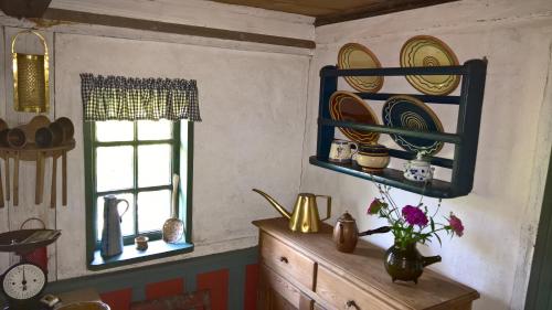 a kitchen with plates on the wall and a window at Thurup Hus in Assens