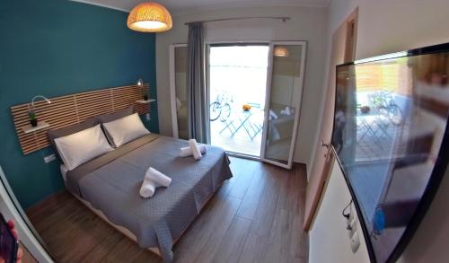 a bedroom with a bed with two towels on it at veraghi apartment 1 in Lefkada