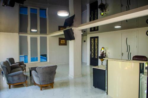 a living room with two chairs and a lobby at Hotel S.R in Tbilisi City