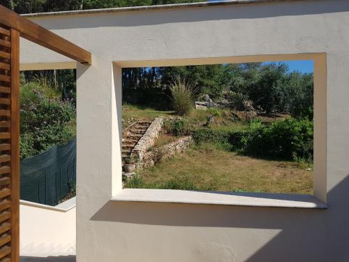 a window view of a garden from a house at La Gazza in Itri