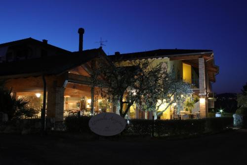 a house at night with a sign in front of it at Locanda Arizona in Bardolino
