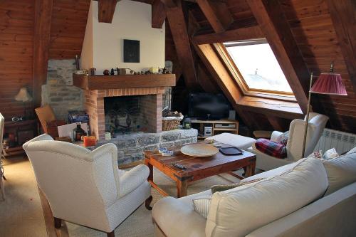 a living room with a couch and a fireplace at Salardu centro atico duplex NA in Salardú