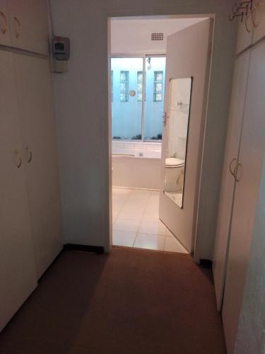 a hallway with a door and a mirror at Fourways Guest Lodge in Johannesburg