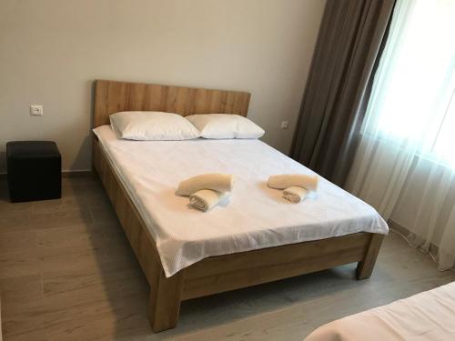 a bedroom with a bed with two towels on it at Hotel CHARLI in Gonio