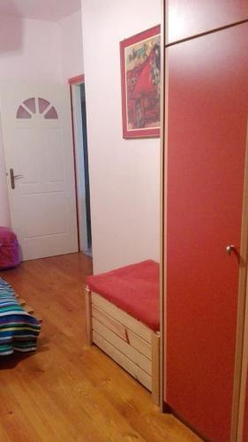 a room with a red bench and a door at Wanderer's Lodge in Sparti