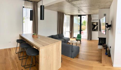 a kitchen and living room with a large wooden island at Villa Sunny Garden in Barbat na Rabu