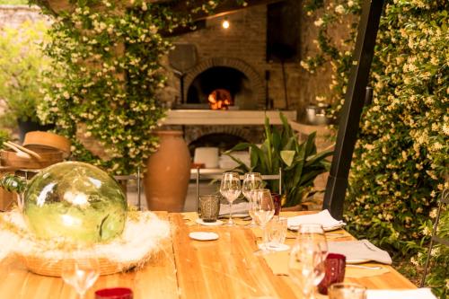 a table with wine glasses on it with a fireplace at La Barchessa di Villa Pisani in Lonigo