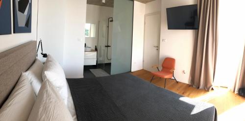 a bedroom with a bed and a bathroom at Villa Sunny Garden in Barbat na Rabu