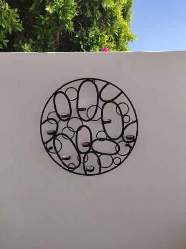 a metal plate on the side of a white wall at Xenones Lindos in Líndos