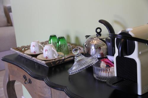 a black table with a tea set on top of it at Le Pré de l'Aube in Montjoyer