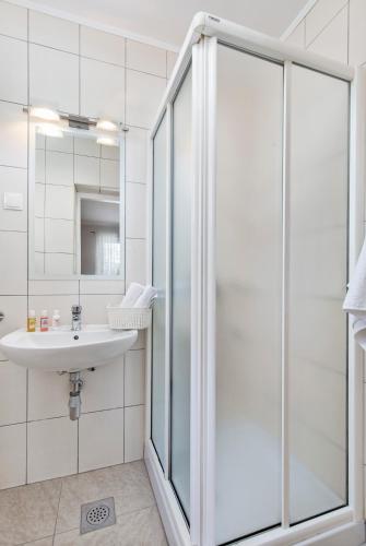 a bathroom with a shower and a sink at Apartman Ivan in Malinska