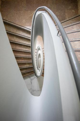 a spiral staircase in a building with a window at Hotel Mediterraneo in Lignano Sabbiadoro