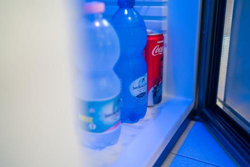 a row of bottles sitting on a window sill at Hotel Mediterraneo in Lignano Sabbiadoro