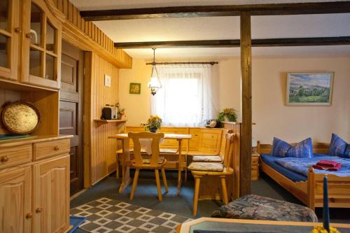 a room with a bed and a table and a bed and a bedroom at Ferienwohnung Kretzschmar in Kirnitzschtal