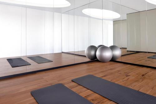 a yoga room with yoga mats and mirrors at Vida Emirates Hills in Dubai