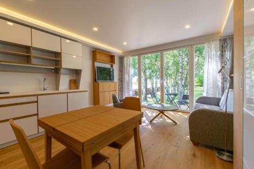 a kitchen and living room with a table and a couch at Modern Sea View Apartments by Villa Kuus Sõlme in Kuressaare