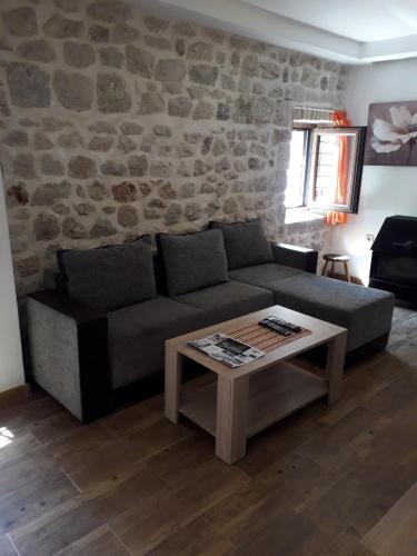 a living room with a couch and a coffee table at Apartments Ana in Kotor
