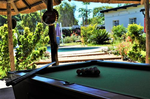 a pool table in the middle of a yard at Natwange Backpackers in Lusaka