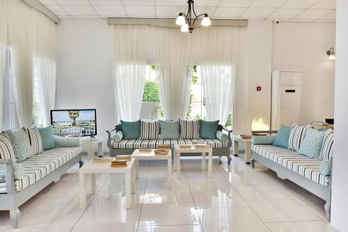 a living room with two couches and a table at Acrotel Elea Beach in Elia