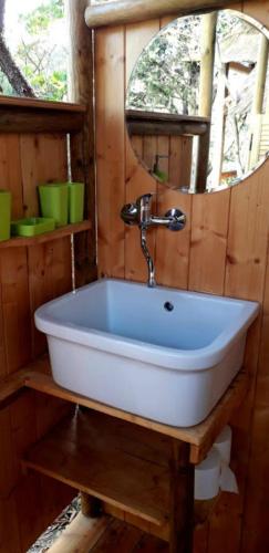 a white sink in a bathroom with a mirror at Stazzu la Capretta Farm Camping & Guest Rooms in Olbia