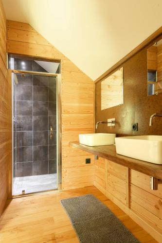 une salle de bain avec deux lavabos et une douche dans l'établissement Ecolodges de Loire & Spa, à Gennes