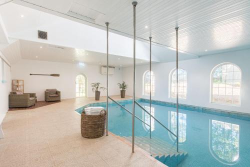 an indoor swimming pool with a glass wall at The Rosevine in Porthscatho