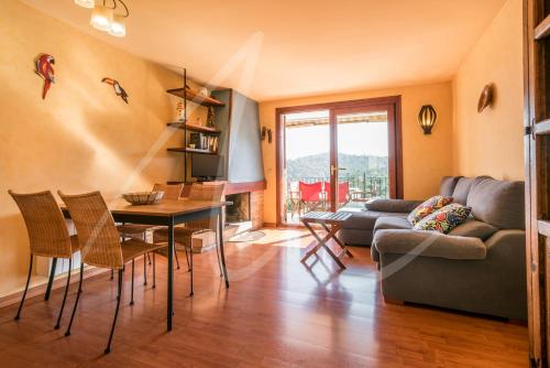 a living room with a couch and a table and chairs at Antora B, by SeaMount Rentals in Calella de Palafrugell
