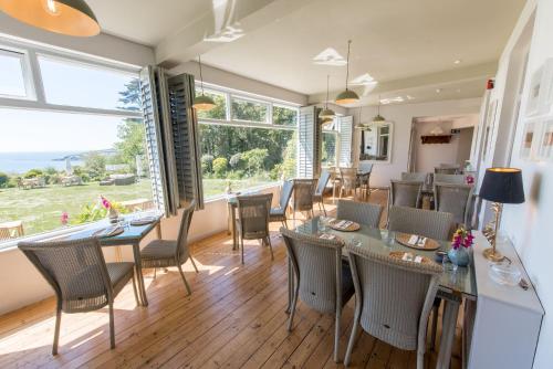 a dining room with chairs, tables and chairs at The Rosevine in Porthscatho