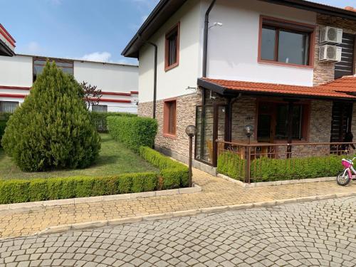 a house with a bike parked in front of it at PANTELI APART HOUSE in Aheloy