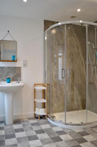a bathroom with a shower and a sink at Caliburn in Alyth
