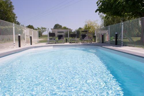 The swimming pool at or near Le Charhido