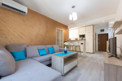 a living room with a couch and a tv at Apartment Medusa in Risan