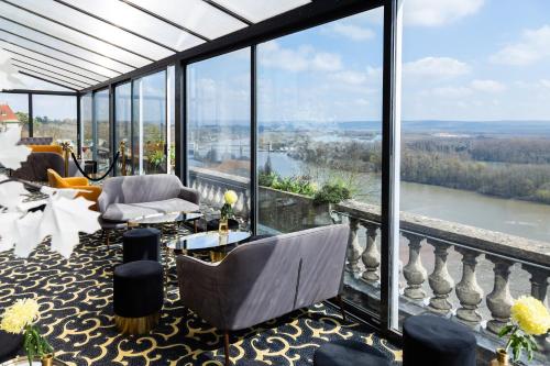 a living room with a view of a river at Domaine De La Corniche in Rolleboise