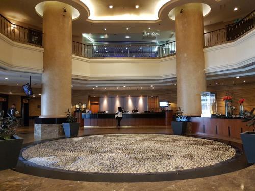 a large lobby with a large rug in the middle at Hotel Armada Petaling Jaya in Petaling Jaya