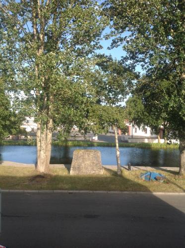a park with a lake and trees and a bench at Harbour House in Tullamore