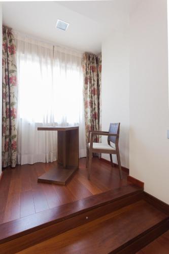 a room with a table and a chair and a window at Soho Boutique Oviedo in Oviedo