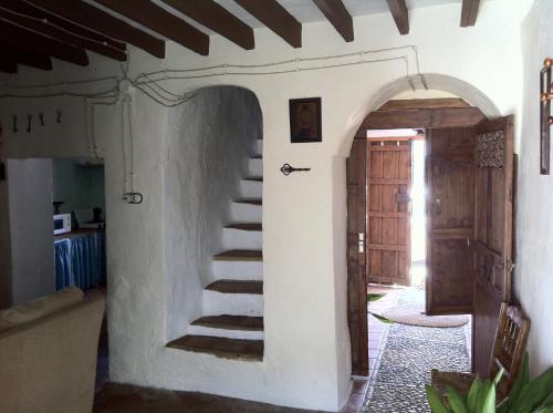a room with a staircase in a house with a door at La Casa de Corruco in Casabermeja