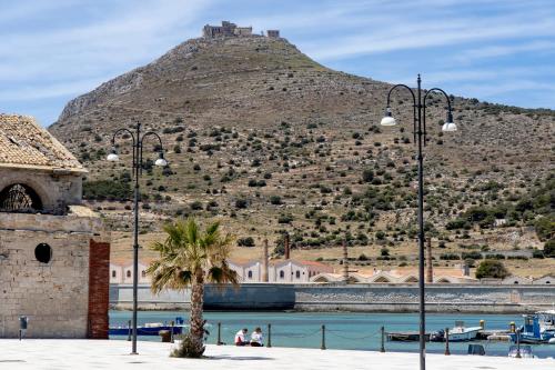 a hill with a castle on top of it at Dimora La Torre Room in Favignana