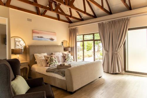 a bedroom with a bed and a large window at 2 On Lismore Guesthouse in Tokai
